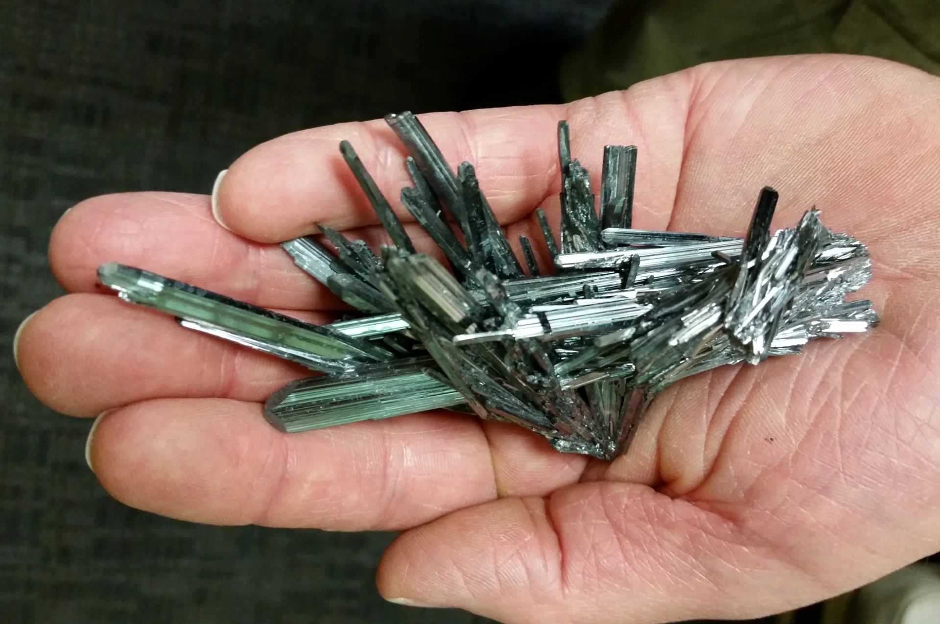 A specimen of naturally occurring stibnite with metallic needle-shaped crystals